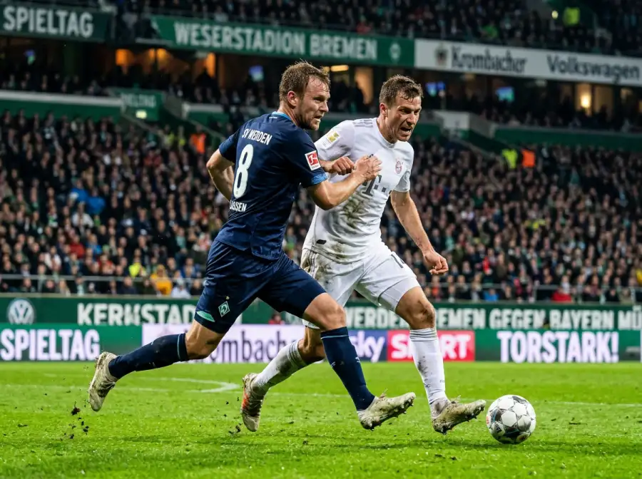 Zwei Fussballspieler im Zweikampf um den Ball während eines Abendspiels unter Flutlicht
